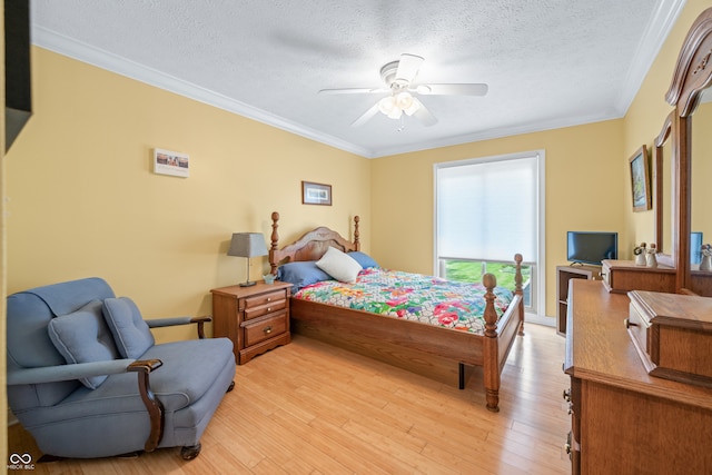 bedroom featuring light wood-type flooring, ceiling fan, crown molding, and a textured ceiling