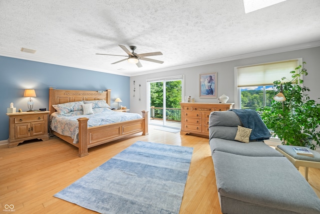 bedroom featuring ceiling fan, a textured ceiling, light wood-type flooring, and access to exterior