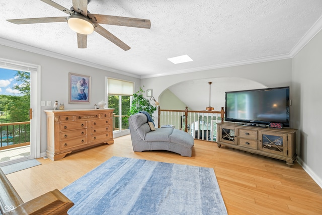 living room featuring hardwood / wood-style floors, ceiling fan, and a healthy amount of sunlight