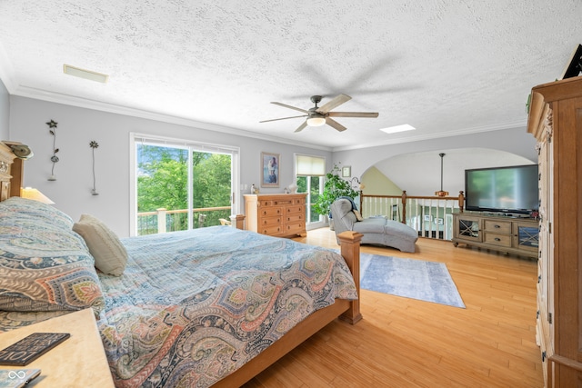 bedroom with crown molding, ceiling fan, hardwood / wood-style flooring, and a textured ceiling