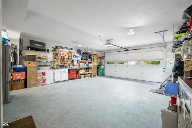 garage with a garage door opener and a workshop area