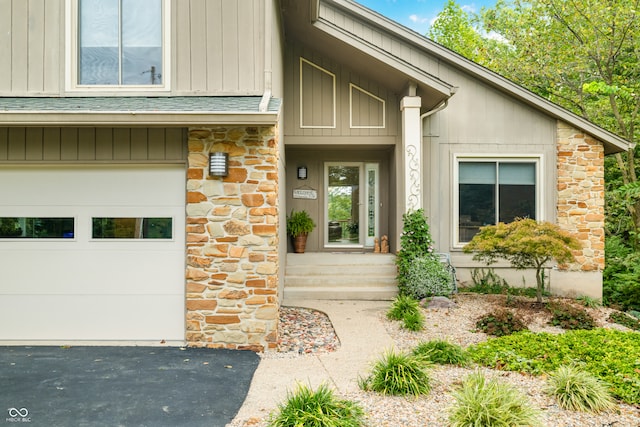 view of exterior entry with a garage