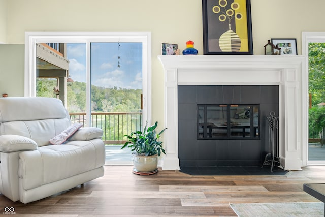 sitting room with a fireplace and hardwood / wood-style flooring