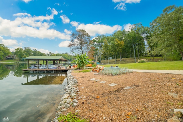 dock area featuring a lawn and a water view