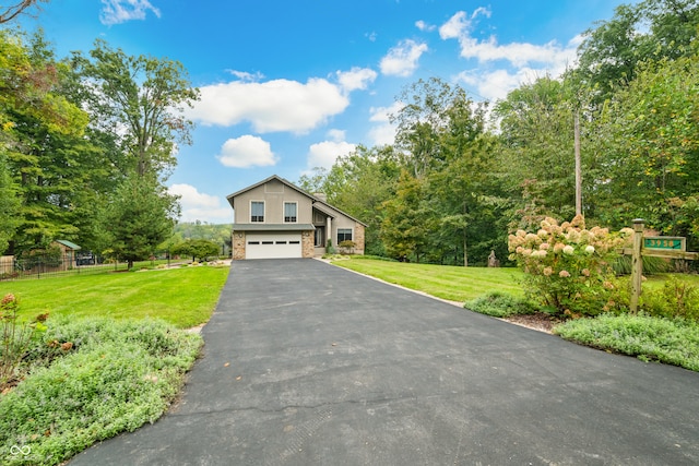 view of front of home featuring a garage and a front yard