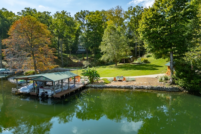 dock area with a yard and a water view