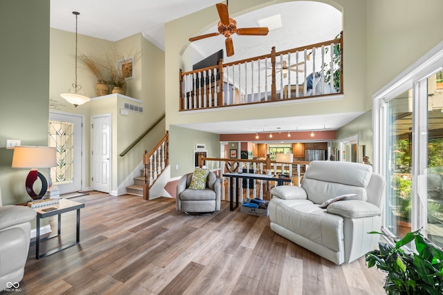 living room featuring hardwood / wood-style flooring and high vaulted ceiling