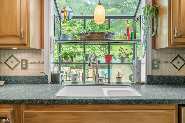 kitchen with decorative backsplash, plenty of natural light, and sink