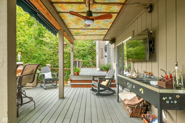 wooden deck featuring ceiling fan