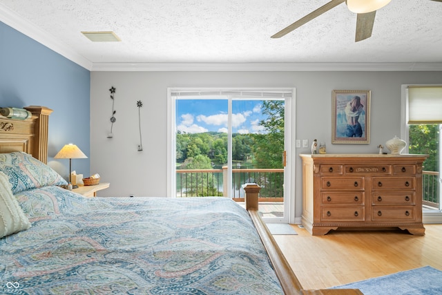 bedroom with ceiling fan, a textured ceiling, access to exterior, and hardwood / wood-style flooring