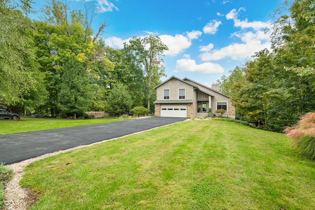 view of front of house featuring a garage and a front lawn