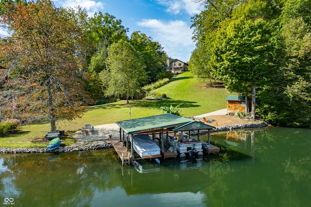 view of dock with a yard and a water view