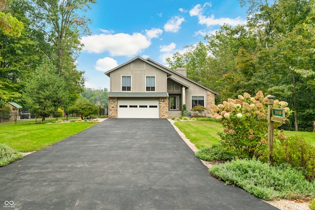 view of front of property with a front yard and a garage