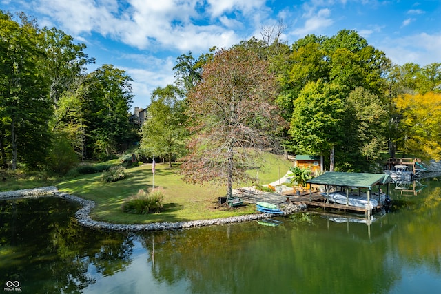 view of dock featuring a lawn and a water view