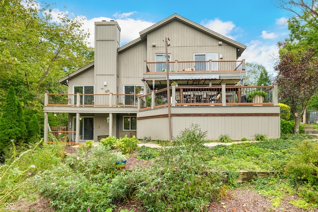 rear view of property featuring a wooden deck