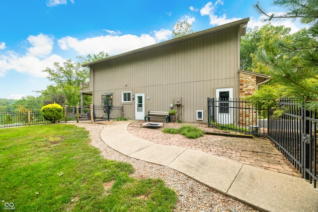 rear view of property featuring a yard