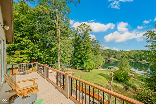 deck with a yard and a water view