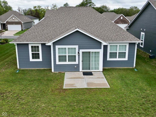 rear view of house with a yard and a patio