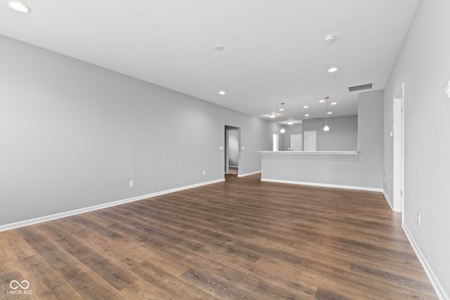 unfurnished living room featuring dark wood-type flooring