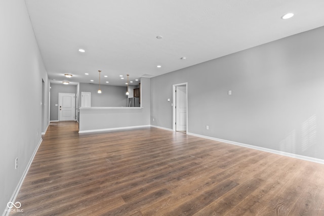 unfurnished living room featuring dark wood-type flooring