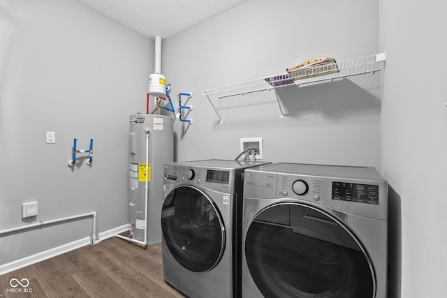 laundry room with separate washer and dryer, electric water heater, dark wood-type flooring, and a textured ceiling