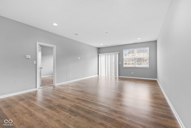 spare room with dark wood-type flooring