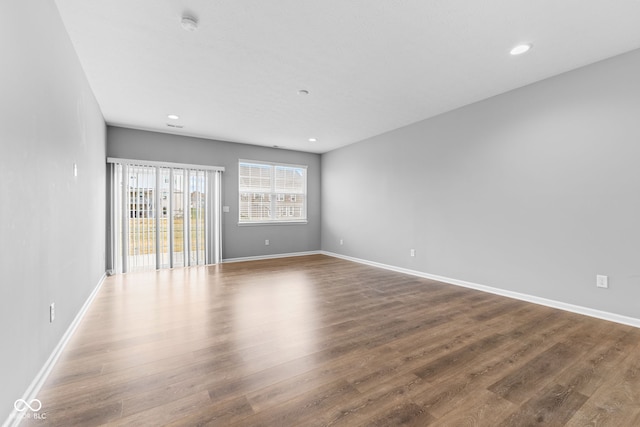 unfurnished room featuring dark hardwood / wood-style flooring