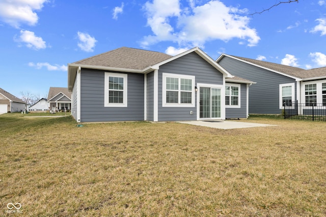 rear view of property featuring a yard and a patio