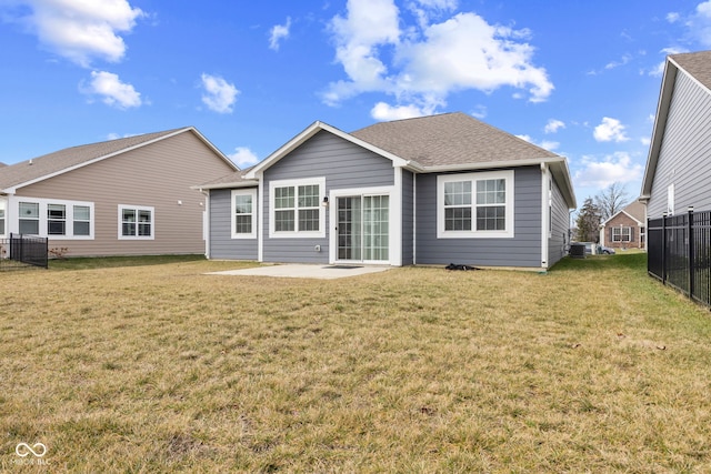 rear view of property with a yard and a patio area