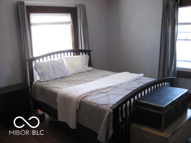 bedroom featuring dark wood-type flooring and multiple windows