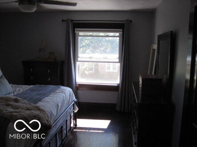 bedroom featuring dark hardwood / wood-style flooring and ceiling fan