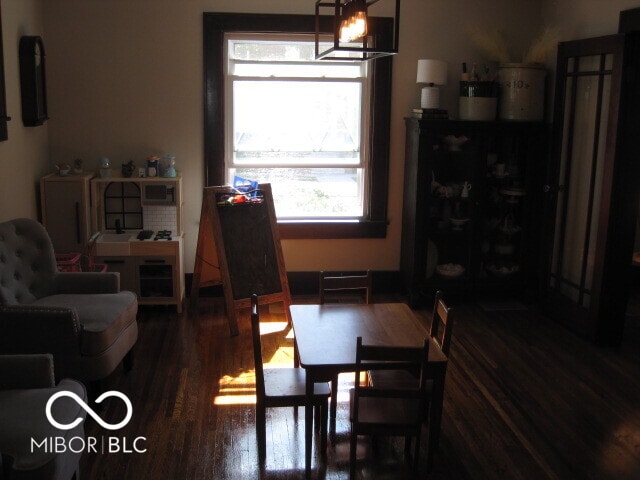 dining room with a chandelier and dark hardwood / wood-style flooring