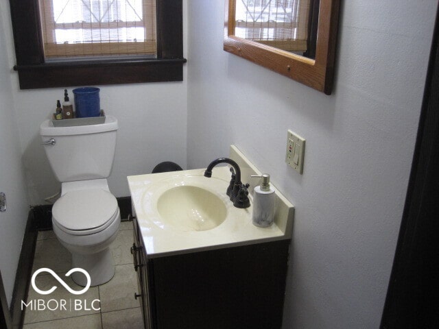 bathroom with vanity, toilet, and tile patterned floors