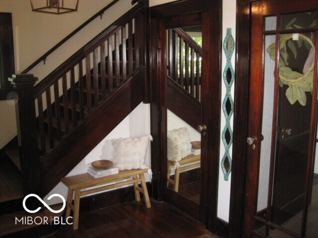 staircase featuring wood-type flooring