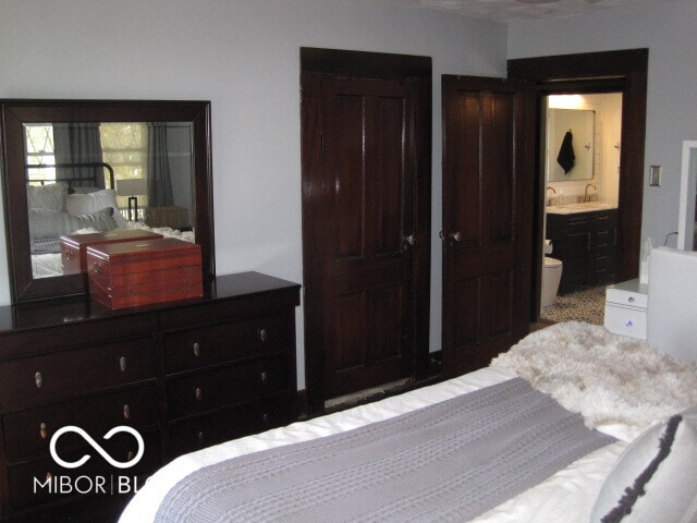 carpeted bedroom with ensuite bathroom