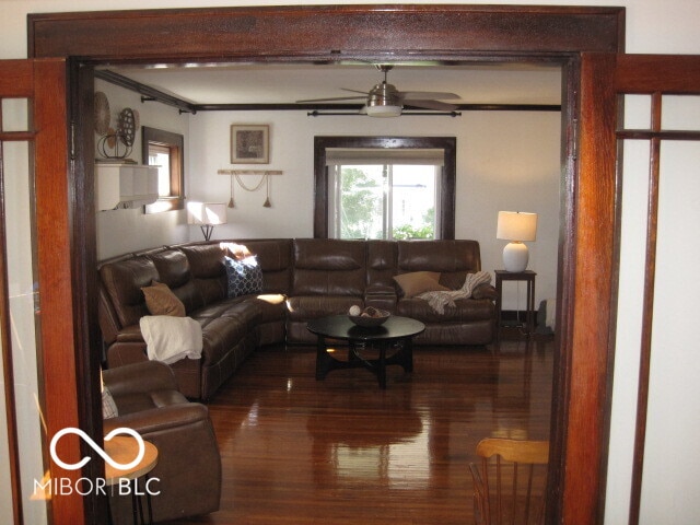 living room featuring crown molding, ceiling fan, and hardwood / wood-style floors