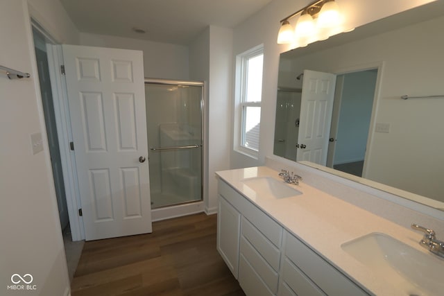 bathroom with vanity, hardwood / wood-style flooring, and a shower with shower door