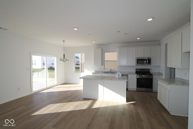 kitchen with white cabinetry, hardwood / wood-style floors, and stainless steel appliances