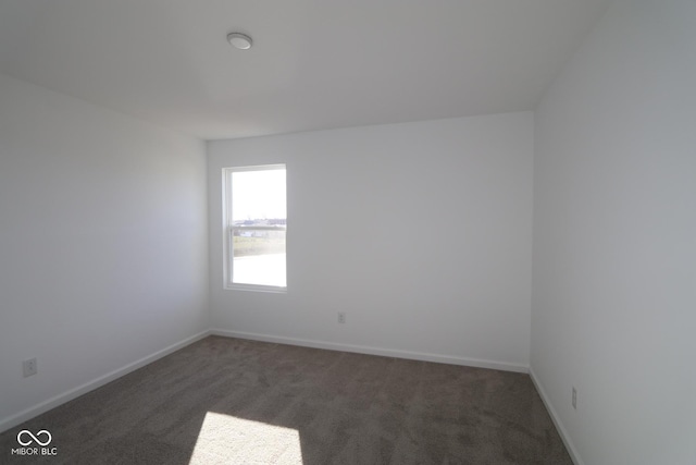 empty room featuring dark carpet