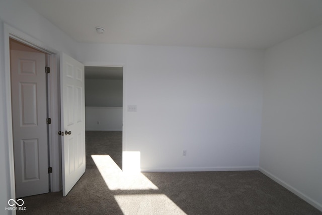 empty room featuring dark carpet