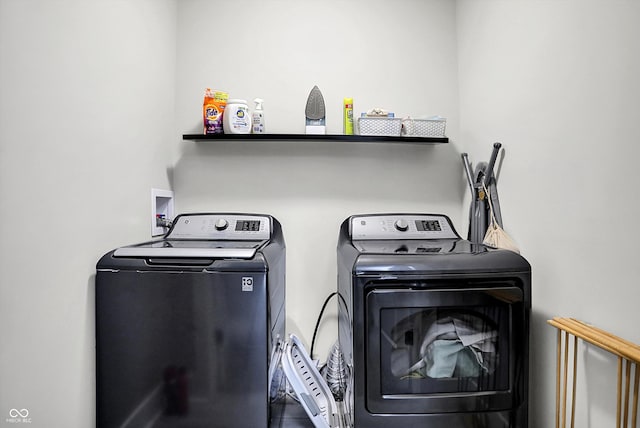 clothes washing area featuring separate washer and dryer