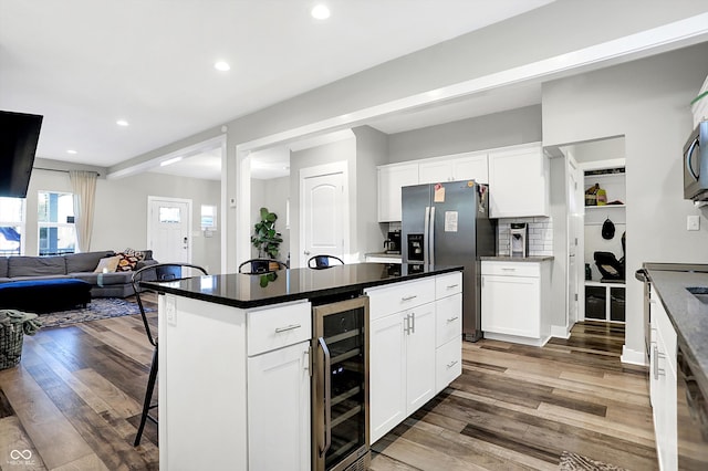 kitchen featuring dark wood-type flooring, white cabinets, and beverage cooler