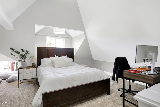 bedroom featuring light colored carpet and lofted ceiling