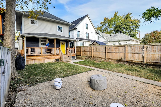 back of property with a lawn