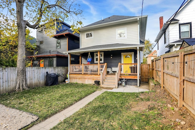 back of property featuring a lawn and a wooden deck