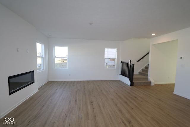 unfurnished living room with hardwood / wood-style floors