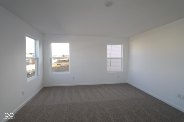 empty room with dark carpet