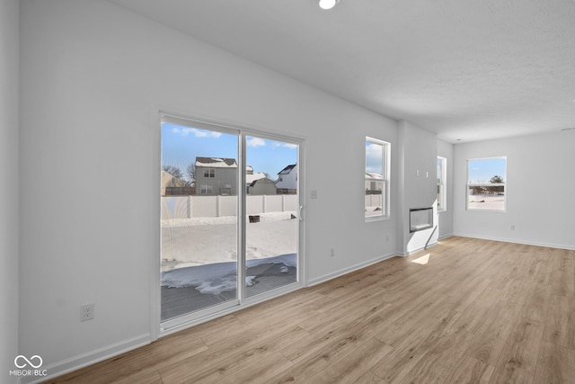 unfurnished living room with light hardwood / wood-style flooring