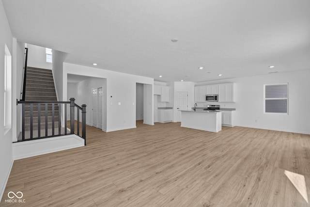 unfurnished living room featuring light wood-type flooring