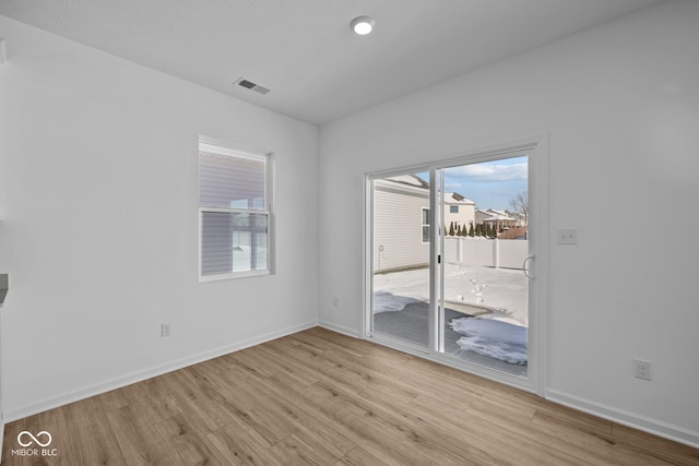 empty room with light hardwood / wood-style flooring